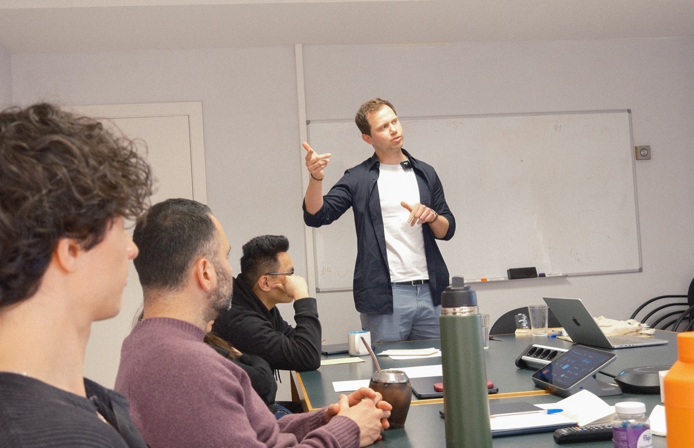 Patrick Vogel delivering a live sales workshop to a team around a table